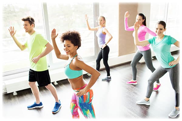 group-of-smiling-people-dancing-in-gym