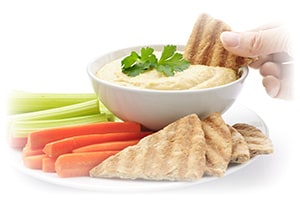 hand-dipping-pita-in-hummus