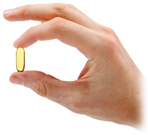 hand-with-fish-oil-capsule-isolated-on