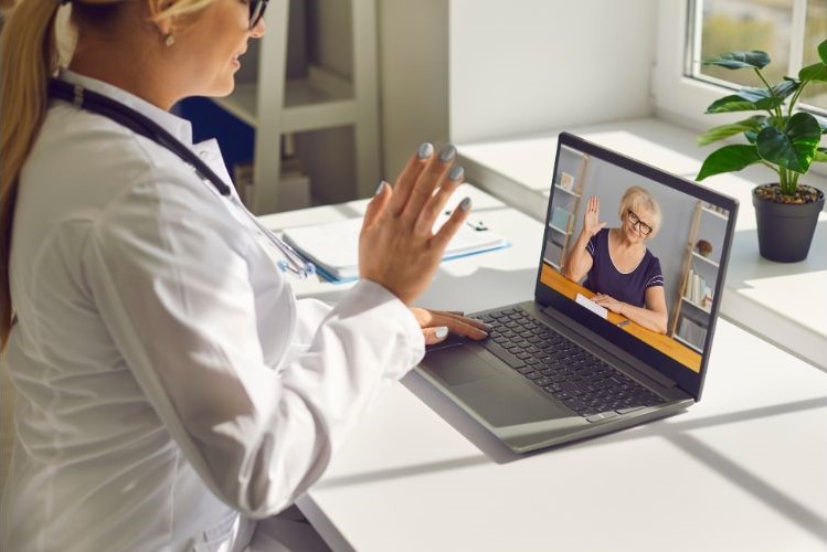 Doctor waving to her senior patient
