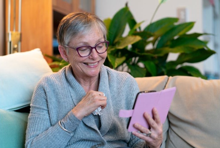 A senior woman using her gadget