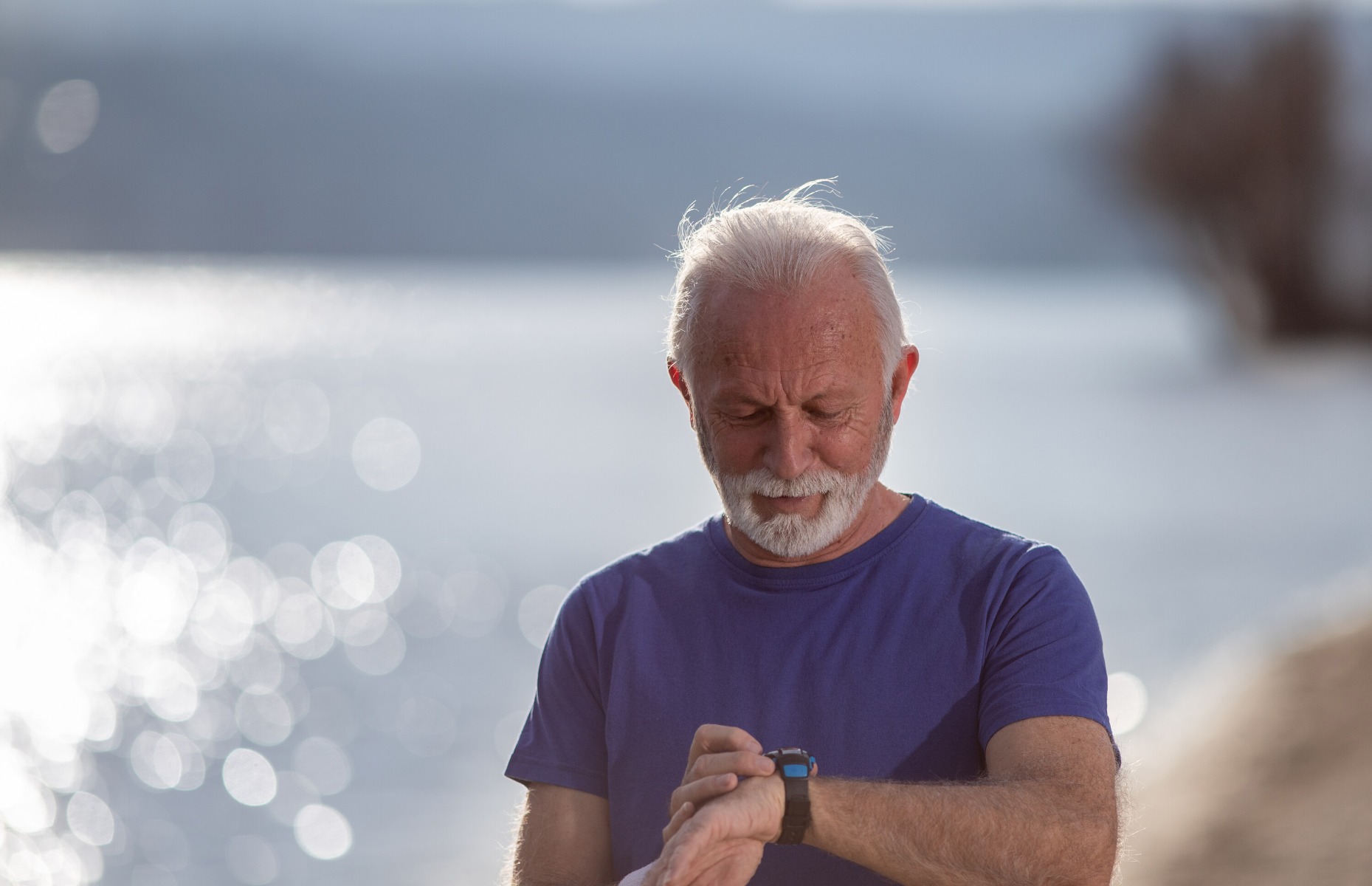 An old person using a smartwatch