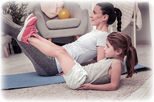 girl-joyfully-doing-exercises-with-her-65651535