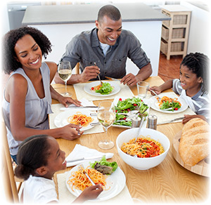 smiling-family-dining-together-3135572