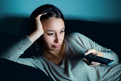 young-woman-watching-television-alone-at-67846569